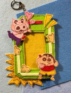 a keychain with an image of two cartoon characters hanging from it's side