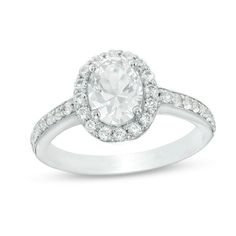 an oval cut diamond ring with pave set shoulders