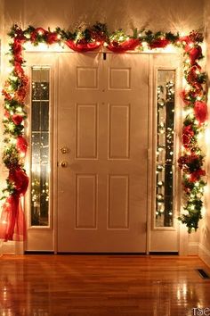 a door decorated with christmas lights and garland