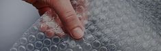 a person's hand on top of bubble wrap