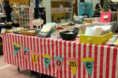 a table that has some items on it and people in the background looking at them