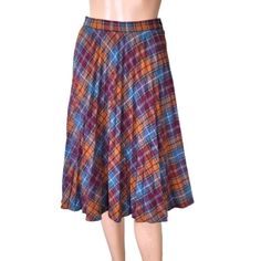 True vintage pleated plaid full wool skirt Made by ILGWU Int Ladies Garment Union  AFL-CIO According to the label the skirt is made between 1974 to 1995- most probably in the 70s Size zipper fastening. Colors- blue, red burgundy, orange, beige and brown stripes. Size 9-10, corresponds size S or M. Please see the measurements and decide before you buy. Measurements /flat/ - waist 27''/68cm hip - full length 25.5''/65cm Preowned in great condition. No holes or rips, no stains. Please see pictures Retro Pleated Bottoms For Fall, Retro Plaid Pleated Skirt For Fall, Vintage Multicolor Skirt For Fall, Vintage Plaid Full Skirt, Retro Plaid Flared Skirt, Retro Plaid Knee-length Skirt, Retro Accordion Pleated Skirt For Fall, Retro Knee-length Plaid Skirt, Vintage Plaid Pleated Skirt