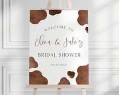 an easel with a sign that says welcome to ellen and alex's bridal shower