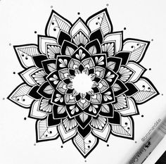 a black and white drawing of a flower with leaves on the petals, surrounded by crayons