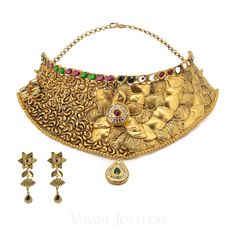 22K Gold Flower Choker Necklace & Earring Set W/Multi Gems for women. This antique gold flower choker necklace with matching earrings is decorated with Kundan, ruby, and emerald stones. The piece secures with a snare Closure. The Jhumki drop earrings have a thick stem that is secured with a post-screw-back. Gold weight 97.8 gms Gold Hallmarked Emerald Necklace For Wedding, Ceremonial Hand Set Emerald Necklace In Gold, Ceremonial Hand-set Gold Emerald Necklace, Heavy Gold Emerald Necklace For Celebration, Gold Emerald Necklace For Formal Festivals, Formal Gold Emerald Necklace For Festivals, Gold Antique Necklace, Floral Choker, Flower Choker Necklace