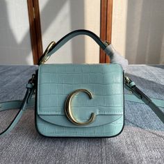 Chlo C Bag crossbody bag presents a fashionable and bright design style, with the iconic gold "C" letter logo decorated on the cascading flap. Glossy calfskin combined with suede calfskin, masculine meets feminine charm, thick leather shoulder strap, full of urban style. The adjustable and detachable long shoulder strap of the Chloé C letter logo series can be worn long and cross-body, while the wide leather short strap can be carried comfortably by hand. - Made of imported glossy calfskin and suede calfskin - 1 long adjustable and removable leather strap - 1 short leather strap - 1 back flat pocket - Large main compartment - 1 inner cotton canvas zippered flat pocket - Beautiful Hidden push lock closure - Cotton canvas lining - Carry method: long shoulder, short shoulder, crossbody or han Chloe C Bag, C Letter Logo, C Letter, Bright Design, Lv Purse, Hot Bags, Gold C, Fabric Tote Bags, Medium Handbags