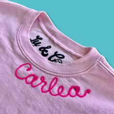 a pink t - shirt with the word careless embroidered on it's chest and back