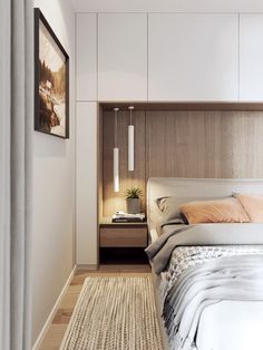 a bedroom with a bed, nightstands and pictures hanging on the wall above it