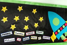 a bulletin board decorated with stars and a rocket ship