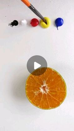 an orange sliced in half with paint and markers