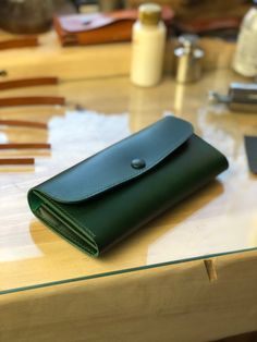 a green wallet sitting on top of a table