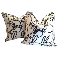 two pillows with black and white designs on them