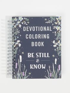 a spiral notebook with the words,'be still and know'written in white