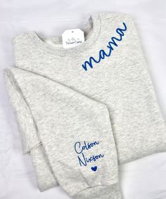 two personalized sweatshirts with the name mama on them are laying next to each other