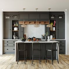 a large kitchen with two chairs and an island in the middle, surrounded by wooden flooring