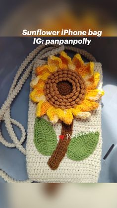 a crocheted phone bag with a sunflower on it