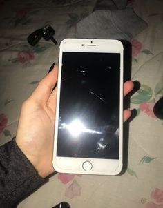 a person holding an iphone in their left hand with the screen partially removed from it