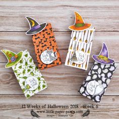 four halloween treat bags on a wooden surface with the words 12 weeks of halloween written on them