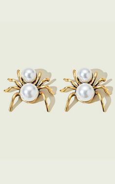 These playful pearl and gold spider earrings are a quirky mix of elegance and spook! With shiny gold legs and pretty pearls for the body, they add a little glam with a dash of creepy-cool charm! Approx. 1” wide, 1” long Curvy Rompers, Grab Bag Gifts, Curvy Swim, Spooky Spiders, Fall Faves, Spider Earrings, Gold Legs, Gold Pearl Earrings, Self Tanner