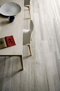 a table with two chairs and a book on it