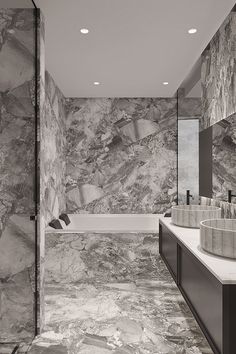 a large bathroom with marble walls and flooring