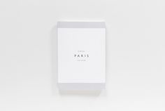 a white box with the word paris printed on it sitting against a white background,