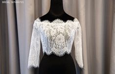 a mannequin wearing a white lace top