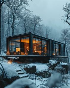 a small cabin in the middle of a snowy forest with rocks and trees around it