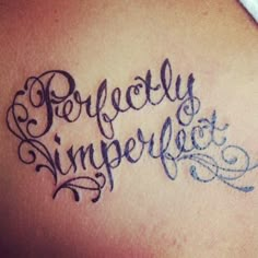 the word perfectly imperfect written in cursive writing on a woman's back