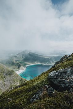 the view from top of a mountain looking down at a body of water