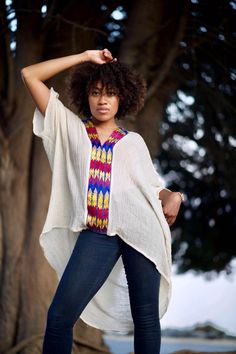 Boldly Cozy With A Boho Twist. Simply-Chic Layering piece, that dresses up or down for any occasion.• V-Neck and flattering drape• 100% Cotton • V-neck • Embroidery By Hand In Ethiopia. • Made in California.• size one size fits most { the size is loose fit it well fit from size 2 to size 12 } • front length 23” from the shoulder. • Machine wash In Delicate cycle or hand was in cold water. Tumble dry low heat for crinkle look. • Color off white / beige/ the embroidery is multi color. Casual White Cotton Poncho, Free Size Short Sleeve Blouse, Casual White Poncho With Batwing Sleeves, Short Sleeve Poncho For Vacation, Casual White Short Sleeve Kaftan, Casual Free Size Top With Batwing Sleeves, Oversized Tunic Top For Vacation, Casual Free Size Batwing Sleeve Tops, White Oversized Casual Poncho