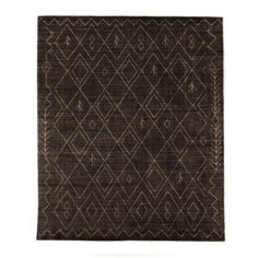 an area rug with brown and white designs on it, in the shape of diamonds