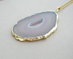 This listing is for one necklace Gray Agate Slice Necklace Gray Agate Pendant Gift for Women Necklace Gray Stone Pendant Long Necklace Agate necklace Healing Boho necklace - Gray Agate Slice silver plated pendant - 24K Gold-plated Brass Cross Chain Shop more Agate Slice Necklace : https://www.etsy.com/shop/BonBonStones?ref=seller-platform-mcnav&section_id=20962520 MY SHOP: https://www.etsy.com/shop/BonBonStones Please contact me with any questions. I'm happy to help! Long Agate Crystal Necklaces As Gift, Long Agate Crystal Necklace Gift, Chalcedony Necklace With Large Pendant For Gift, Agate Slice Necklace, Grey Agate, Cross Chain, Agate Slice, Women Necklace, Agate Necklace