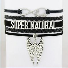 two bracelets with the words super natural and an angel on one side, sitting on top of each other