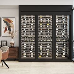 a wine cellar in the middle of a room with chairs and pictures on the wall