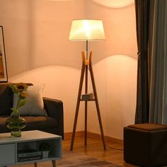 a living room with a couch, table and lamp in it's centerpiece