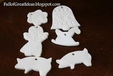 four white ceramic pig ornaments on a table