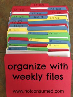 a stack of files with the words organize with weekly files on them in black and red