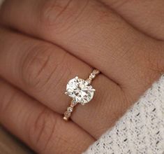 a woman's hand with a diamond ring on it