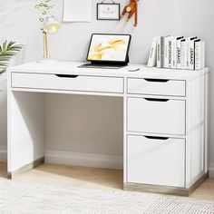 a white desk topped with a laptop computer