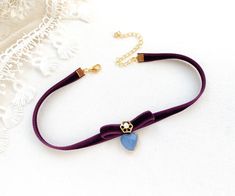 This eye-catching choker necklace is handmade with a soft velvet ribbon in a deep eggplant purple hue. It features a velvet bow, a pearl beaded jewel and a pretty faceted blue heart charm. A one-of-a-kind birthday, anniversary or just because I love you gift for women and girls. * Size ~ Adjustable length 12 - 15 inches with extender chain  Please check your neck size carefully as I do not accept returns or exchanges on these necklaces. Contact me prior to purchase. I am happy to adjust the size Purple Necklaces For Valentine's Day Party, Purple Necklace For Valentine's Day Party, Adjustable Purple Choker For Party, Purple Choker Necklace For Gift, Rosy Posy, Beaded Jewels, Velvet Choker, Because I Love You, Eggplant Purple