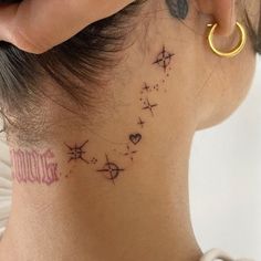 the back of a woman's neck with stars and hearts on her left side