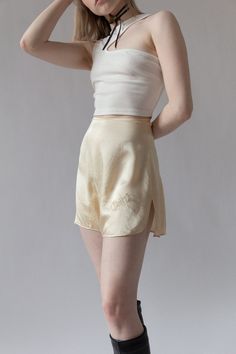 "Bridal silk tap shorts for \"Chippy\" from Bergdorf Goodman in the 1920s. Complete with custom embroidery and tiny mother of pearl buttons at side. The softest cream silk. Very wearable for today and in excellent shape. BRAND / Bergdorf Goodman MATERIAL / 100% Silk CONDITION / Some minor discolorations on back but overall in excellent shape for their age. SIZE / US 0 MEASUREMENTS / Waist - 24\" / Hip - 36\" Nicolette is a size 24 and 5'3" Fitted Silk Cream Bottoms, Elegant Fitted Shorts For Loungewear, Fitted Silk Bottoms Short Length, Summer Silk Cream Bottoms, Cream Silk Bottoms For Summer, Summer Cream Silk Bottoms, Elegant Fitted Cream Shorts, Elegant Short Silk Bottoms, Cream Shorts For Daywear