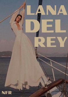 a woman in white dress standing on top of a boat