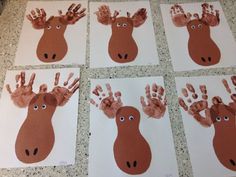 four handprints of different types of animals on white paper with brown and red hands