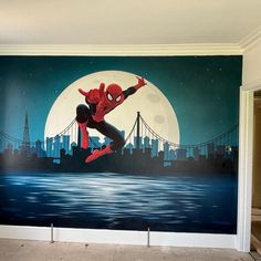 a spider man mural on the side of a wall