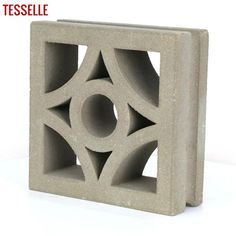 a cement block with an intricate design in the center and two circles on each side