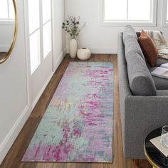 a living room filled with furniture and a large rug