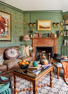 a living room filled with furniture and a fire place in front of a book shelf