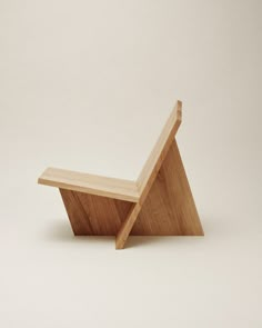 a small wooden bench sitting on top of a white floor